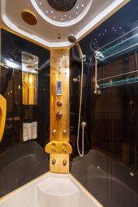 a bathroom with a tub and a shower at Hostel Suputnyk in Lviv