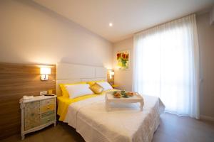Postel nebo postele na pokoji v ubytování Apart-Hotel la Rocchetta