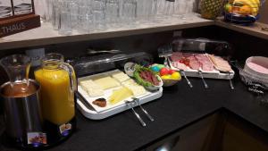 a counter with a tray of food and a blender at Hotel Rubus in Effretikon