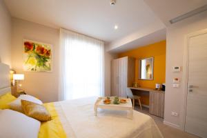 Postel nebo postele na pokoji v ubytování Apart-Hotel la Rocchetta