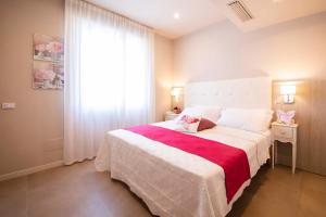 Postel nebo postele na pokoji v ubytování Apart-Hotel la Rocchetta