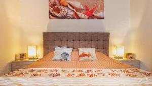 
Tempat tidur dalam kamar di "SARDESIDENCE" Spiaggia Privata WiFi Parcheggio Riservato
