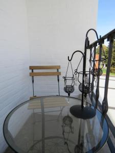 a glass table with a bench on a balcony at Guesthouse La maison de Fille in Diest