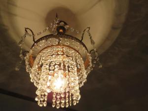 a large chandelier hanging from a ceiling at Guesthouse La maison de Fille in Diest