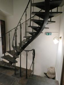 a spiral staircase in a room with a lamp at Guesthouse La maison de Fille in Diest