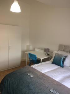 a bedroom with a bed and a desk with a chair at Nestin Liverpool in Liverpool