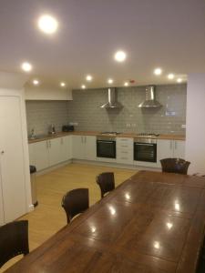 a large kitchen with a wooden table and chairs at Nestin Liverpool in Liverpool