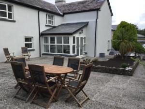 a wooden table and chairs in front of a house at The Stone House, Multyfarnham in Multyfarnham