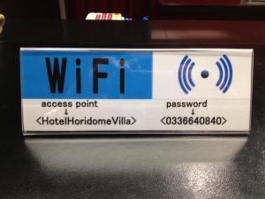 a blue and white sign for an access point at Hotel Horidome Villa in Tokyo