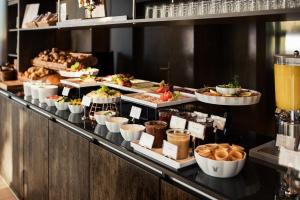 a buffet line with many different types of food at Grimm's Potsdamer Platz in Berlin