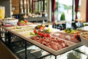 a buffet line with different types of food on display at Grimm's Potsdamer Platz in Berlin