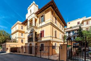 a building with a fence in front of it at Gallo's Holidays St Peter in Rome