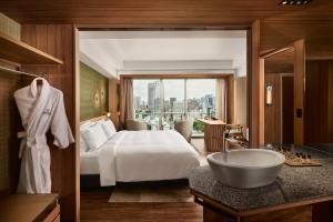 a bedroom with a bed and a bathroom with a tub at The Prince Park Tower Tokyo - Preferred Hotels & Resorts, LVX Collection in Tokyo