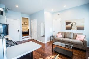 a living room with a couch and a table at Lawrenceville Suites in Pittsburgh