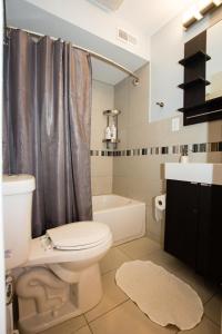 a bathroom with a toilet and a bath tub at Lawrenceville Suites in Pittsburgh