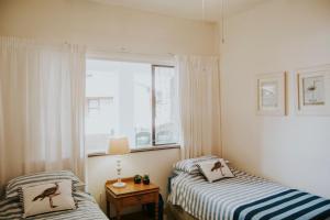 a bedroom with two beds and a window at Shelly Beach, Villa Albatross 2 in Shelly Beach
