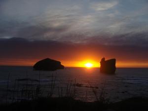 a sunset over the ocean with the sun setting at Casa Dos Mosteiros in Mosteiros