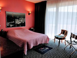 Postel nebo postele na pokoji v ubytování Hotel Fleur de Lys