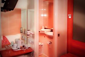 a bathroom with a sink and a toilet and a mirror at Westbury Hotel Kensington in London