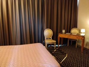 Postel nebo postele na pokoji v ubytování Hotel Fleur de Lys