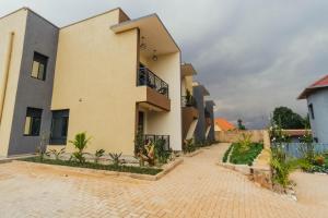 a large building with a courtyard in front of it at Mountain View Hotel & Apartment in Kigali +102 photos