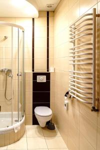 a bathroom with a toilet and a shower at Hotel Relax in Kęty