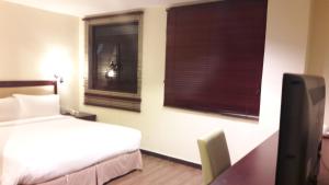 Postel nebo postele na pokoji v ubytování Cheng Ho Hotel