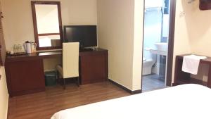 Postel nebo postele na pokoji v ubytování Cheng Ho Hotel