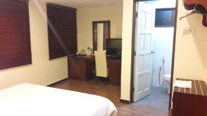 Postel nebo postele na pokoji v ubytování Cheng Ho Hotel