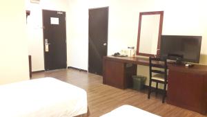 Postel nebo postele na pokoji v ubytování Cheng Ho Hotel