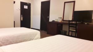 Postel nebo postele na pokoji v ubytování Cheng Ho Hotel
