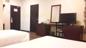Postel nebo postele na pokoji v ubytování Cheng Ho Hotel