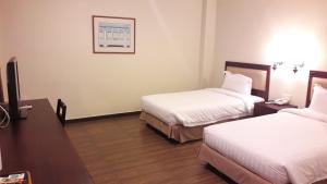 Postel nebo postele na pokoji v ubytování Cheng Ho Hotel