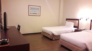 Postel nebo postele na pokoji v ubytování Cheng Ho Hotel