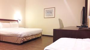 Postel nebo postele na pokoji v ubytování Cheng Ho Hotel