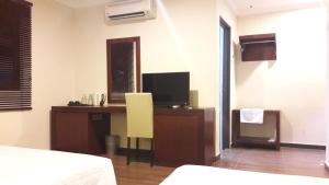 Postel nebo postele na pokoji v ubytování Cheng Ho Hotel