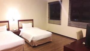 Postel nebo postele na pokoji v ubytování Cheng Ho Hotel