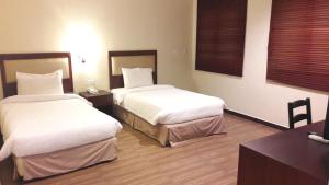 Postel nebo postele na pokoji v ubytování Cheng Ho Hotel