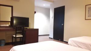 Postel nebo postele na pokoji v ubytování Cheng Ho Hotel