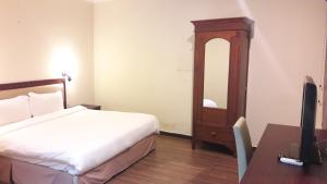 Postel nebo postele na pokoji v ubytování Cheng Ho Hotel