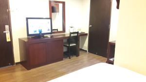 Postel nebo postele na pokoji v ubytování Cheng Ho Hotel