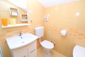 a bathroom with a toilet and a sink at Studio Neven with Sea View in Baška +26 photos