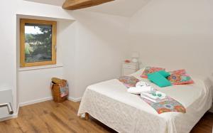 a bedroom with a bed and a window at Gites Domaine du Charouzech in Salles-Curan +36 photos