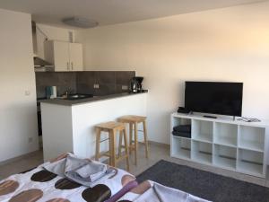 a living room with a kitchen and a television at Tina in Heiligenhaus