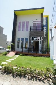 a house with a lawn in front of it at Time Travel B&B in Taitung City