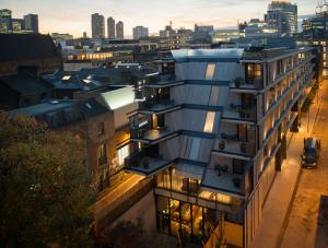 an apartment building with balconies overlooking a city at Nobu Hotel London Shoreditch in London