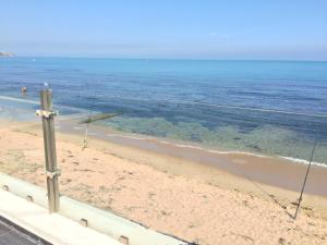 a view of a beach with the ocean at Dar Corniche La Marsa (Adults Only) in La Marsa