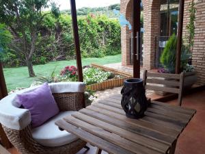 a porch with a wooden table and a couch and a bench at El Mirador De Ruidera in Ruidera