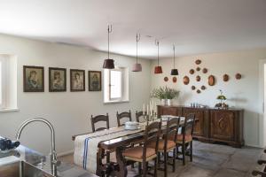 a kitchen and dining room with a table and chairs at Panigai House in Aquiléia