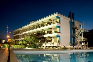 a hotel with a swimming pool in front of a building at Hotel River Palace in Terracina